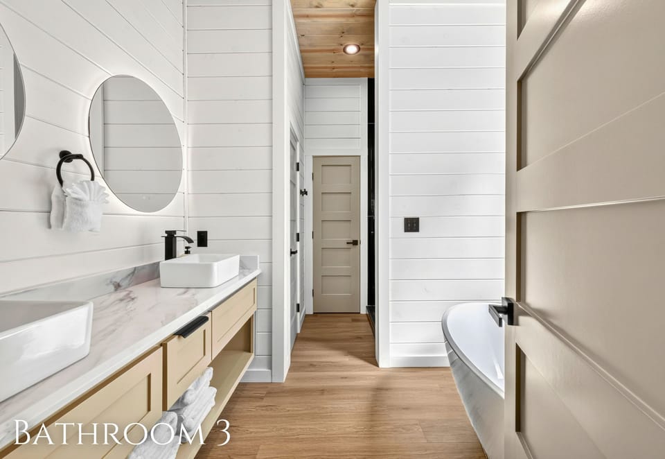 Bright finishes, generous counter space, and a tub-shower combination make this bathroom both comfortable and practical for everyday routines.