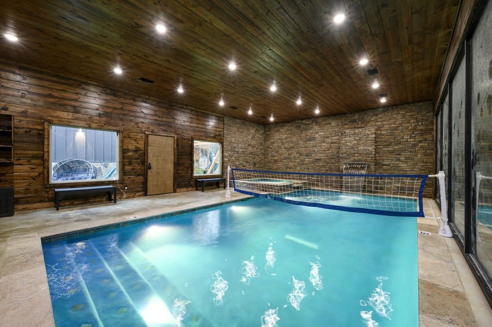 Dive into crystal-clear water beneath a warm wood ceiling on a rainy Broken Bow afternoon.