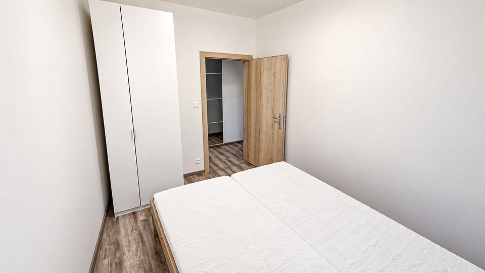 Bright minimalist bedroom with twin beds and ample storage