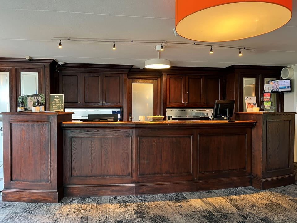 Step up to the classic wooden desk for friendly service.