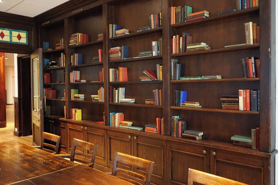 Browse timeless books beside rich woodwork for a cozy pause.
