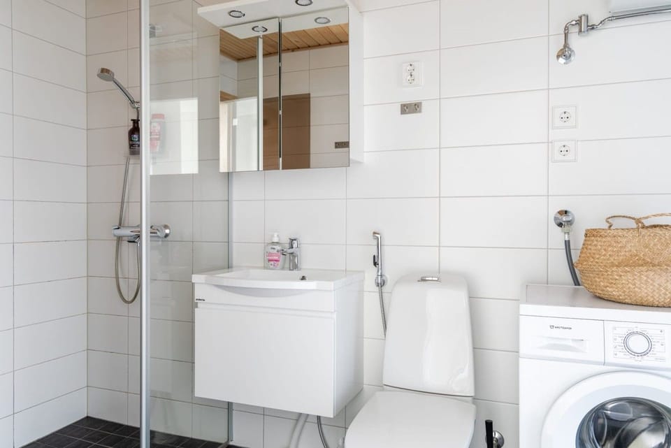 Modern bathroom with walk-in shower, vanity basin, and all essentials for a comfortable stay.
