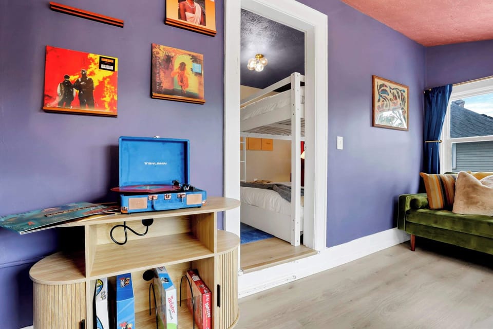 Discover a playful bunk nook tucked behind a colorful gallery wall. A fun retreat that adds extra character to the stay.