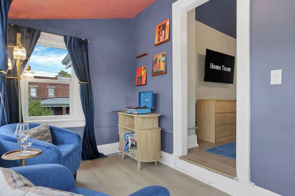 Unwind in a cozy blue seating nook with plenty of natural light. A relaxing spot to read, work, or simply take it easy.