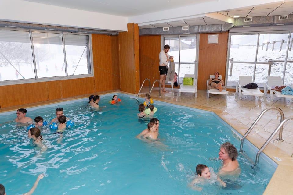 Swimmers make the most of the indoor pool on a snowy day.
