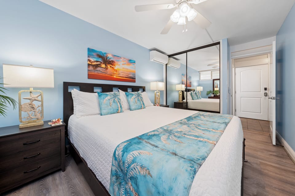 Bedroom softens in turquoise and white, sunset painting echoing the ocean theme.