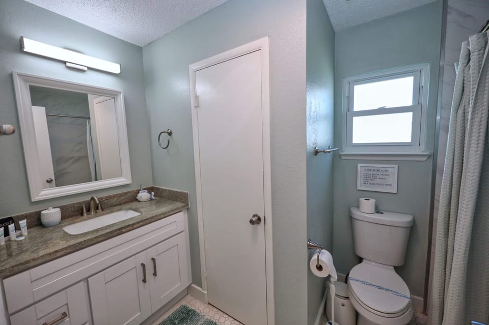 A single vanity & shower/tub combo await in the main-level full bath​