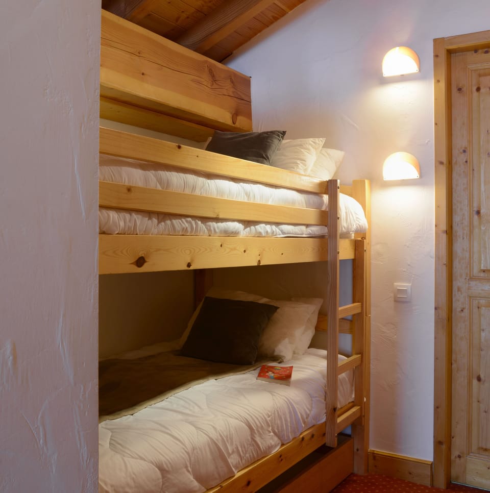 Bunk bed nook tucked beneath the eaves.