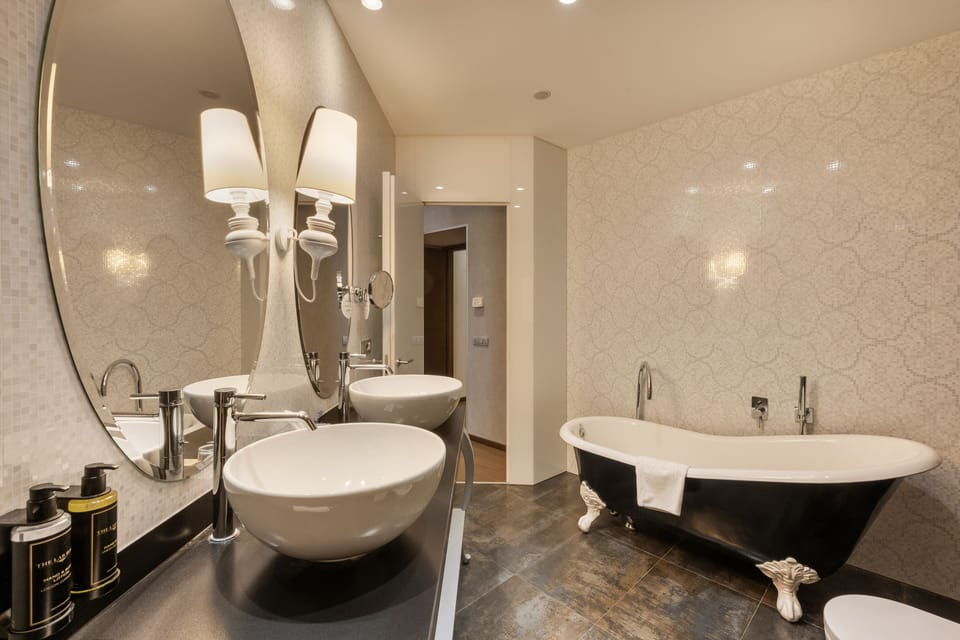 Deluxe Suite | Bathroom | Rainfall showerhead, designer toiletries, hair dryer, bidet