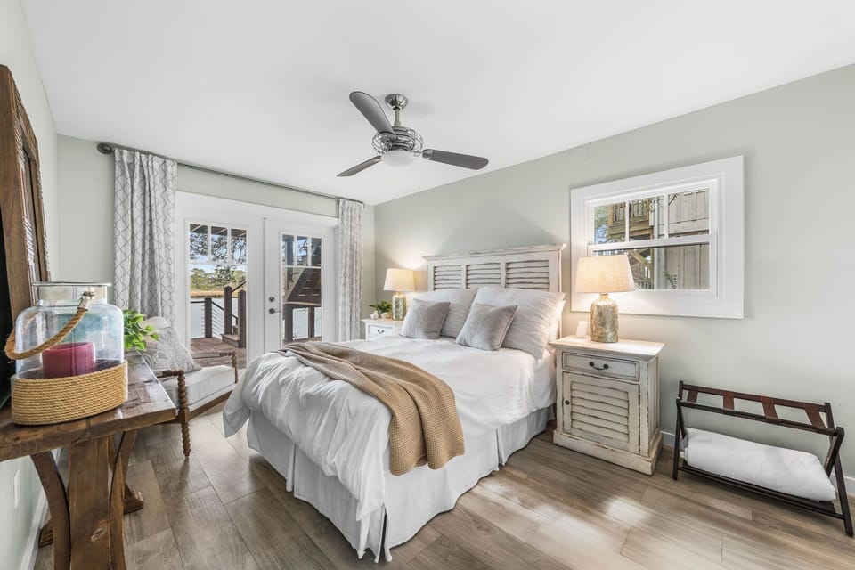 This Master bedroom features a cozy Queen bed and private French doors