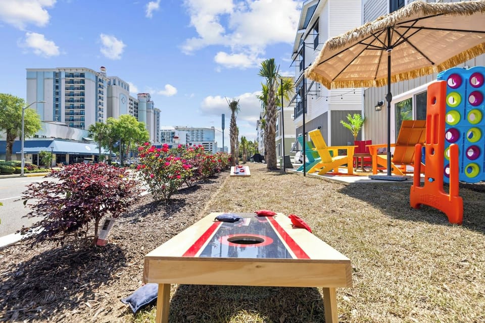 Set up a cornhole tournament in the yard while the city hums across the street. This is the spot where the competitive ones in your group get loud.