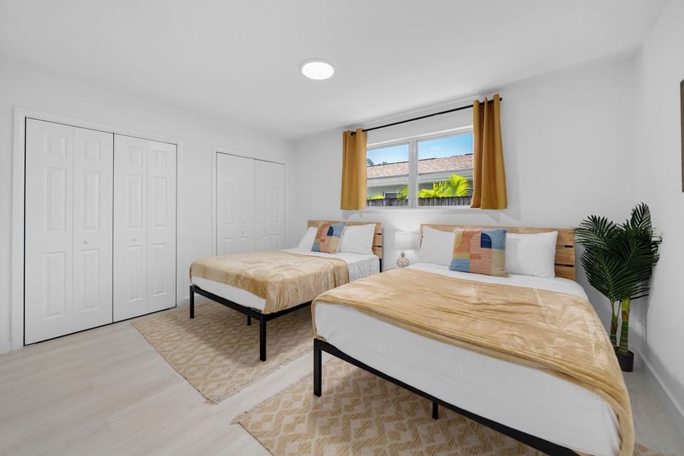 Unit 1 Bedroom 2 features two full beds and plenty of natural light.