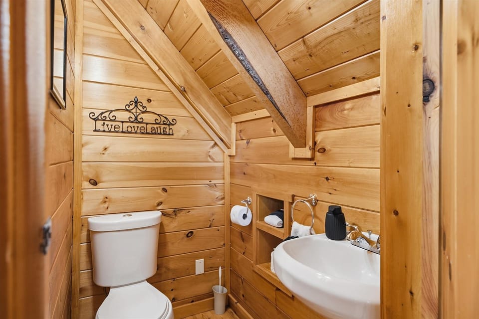 A convenient half bathroom in the game loft means guests do not have to travel downstairs while playing or relaxing upstairs.