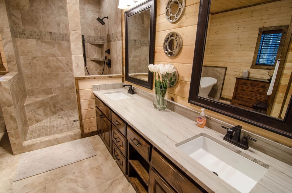 Spa-style bathroom with double vanity and spacious walk-in tiled shower