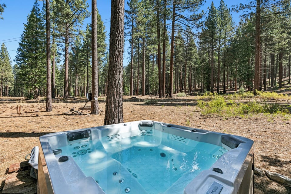 Soak your cares away in this private outdoor hot tub surrounded by towering pines and forest serenity, with nothing but birdsong and fresh mountain air to keep you company.