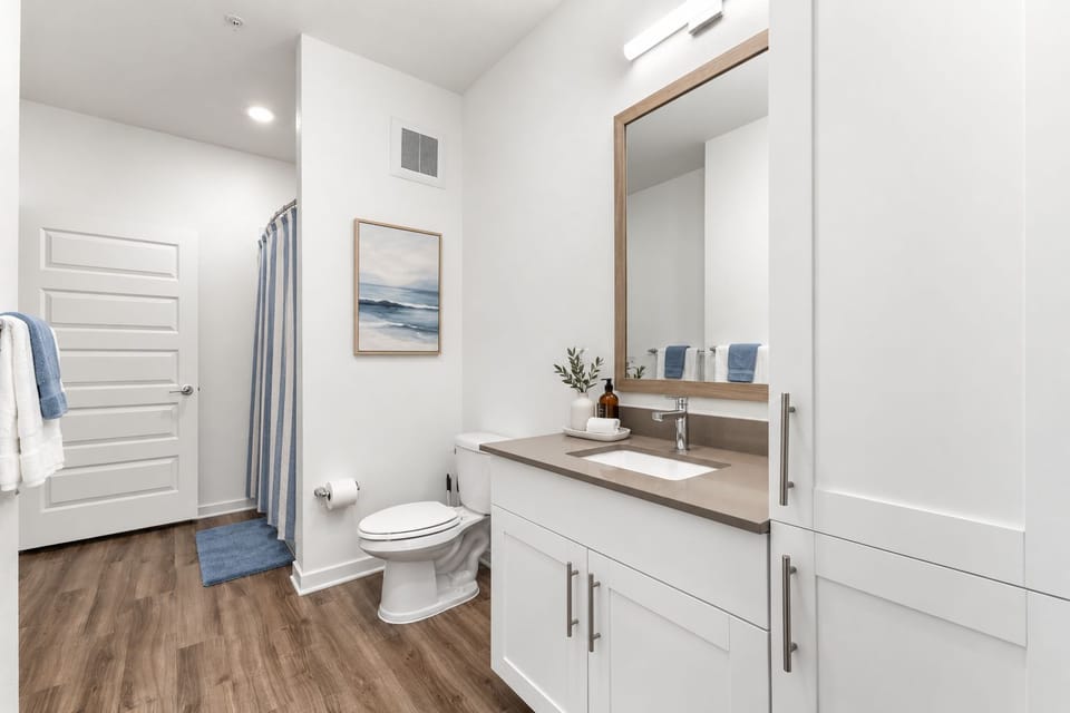 Bathroom with a single vanity and linen storage.