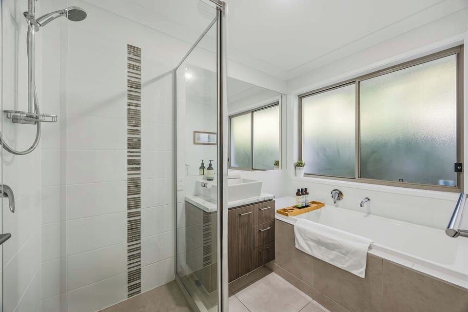 Main bathroom has full length bath and separate shower with handheld option