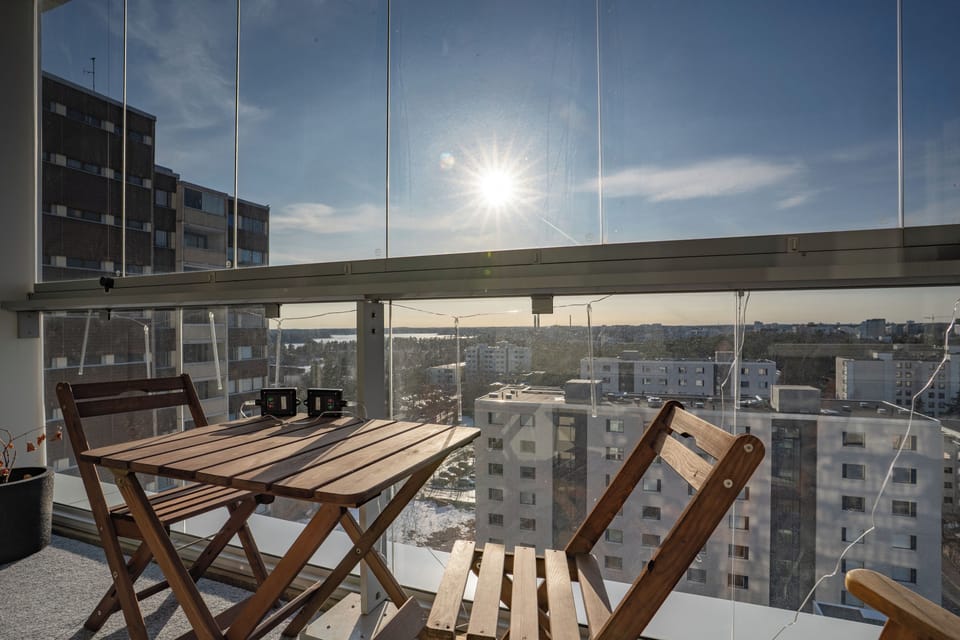 Glass-enclosed balcony with skyline views—perfect for sunset sips.