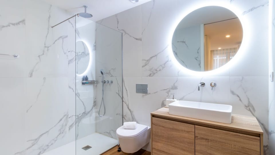 Refresh your senses in this sleek bathroom, featuring a rain shower and a beautifully illuminated mirror for a spa-like experience.
#Bathroom #WalkInShower #LovelyStay
