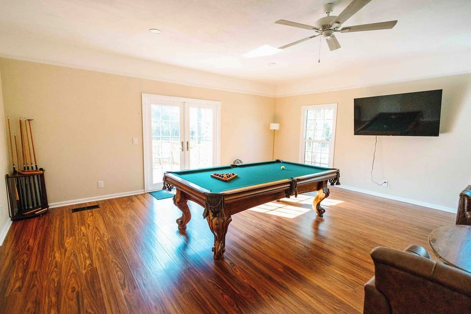 Game room with pool table, TV and French doors for easy entertaining