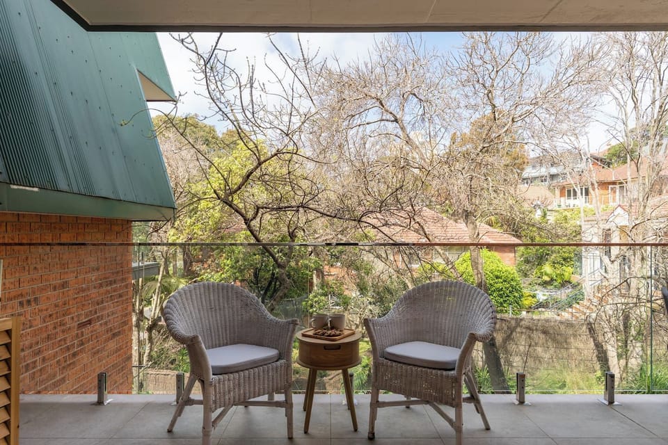 Relaxed outdoor sitting area overlooking the surrounding trees and neighbouring Manly homes