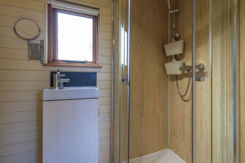 Refresh after a countryside walk in your private ensuite, with a modern shower and warm timber surroundings adding comfort to every adventure.