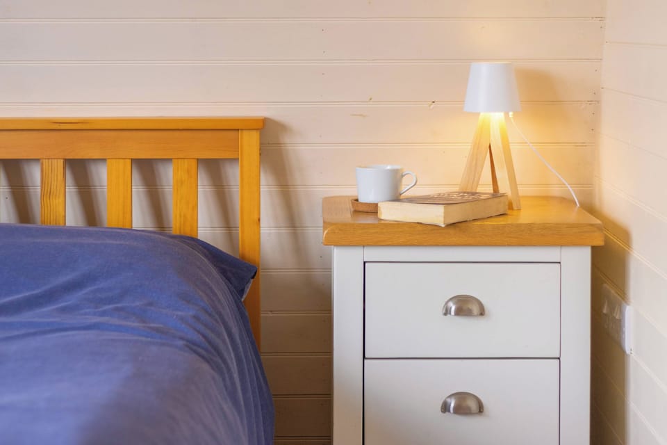 Keep a morning drink or favourite book close at hand, with soft bedside lighting creating a calm atmosphere for a restful night in Otter.