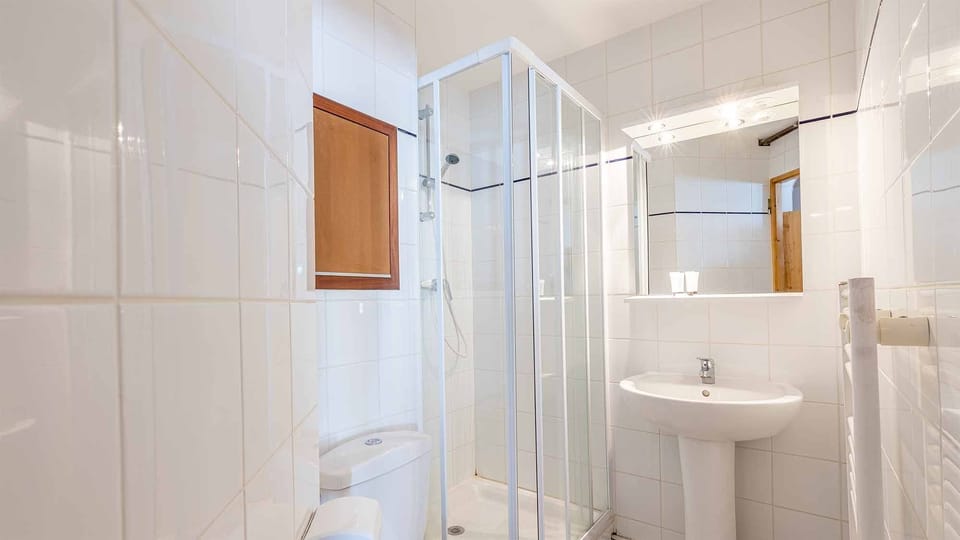Get ready for your day in the bright bathroom.