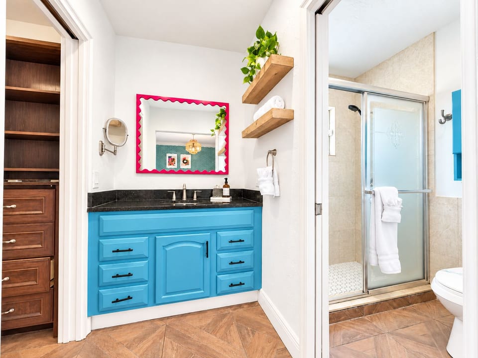 Ensuite bathroom with blue vanity and glass walk-in shower