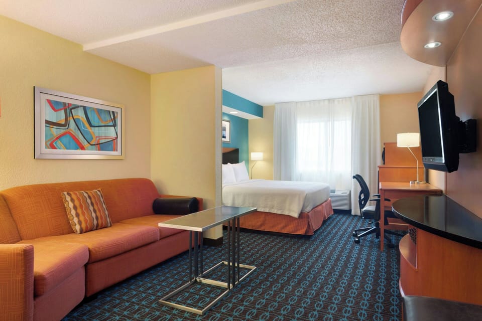 Premium bedding, desk, laptop workspace, blackout drapes