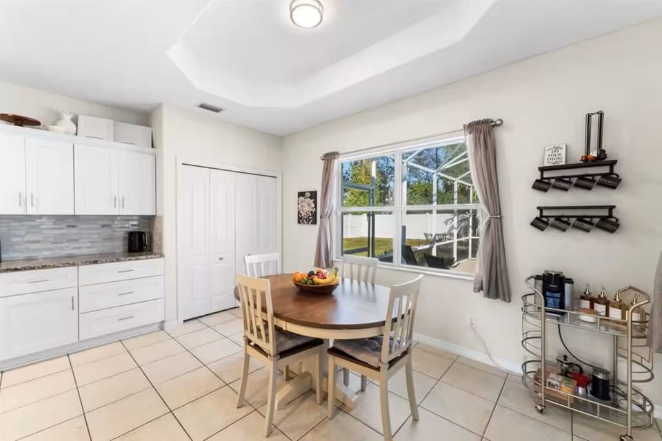 Bright dining nook with backyard views, wine storage, and natural light