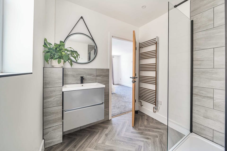 A sleek, modern bathroom featuring a spacious walk-in shower with a glass enclosure.