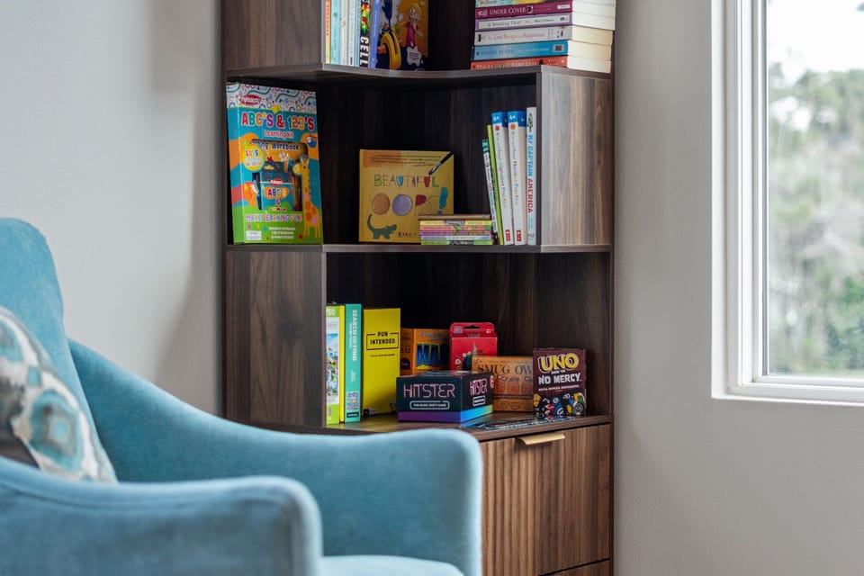 Upstairs lounge with sectional, Smart TV, games & books for relaxing.