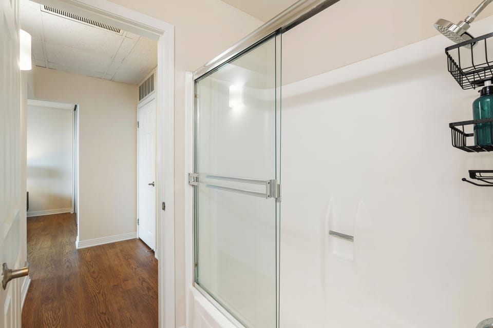 Bedroom with a made bed and wall-mounted television.