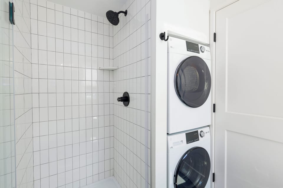 Full bathroom w/ walk in shower and laundry area