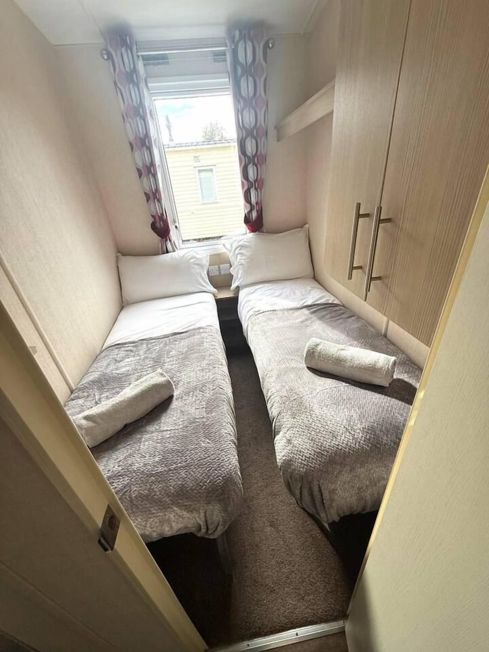 Cozy twin room with natural light and built-in storage
