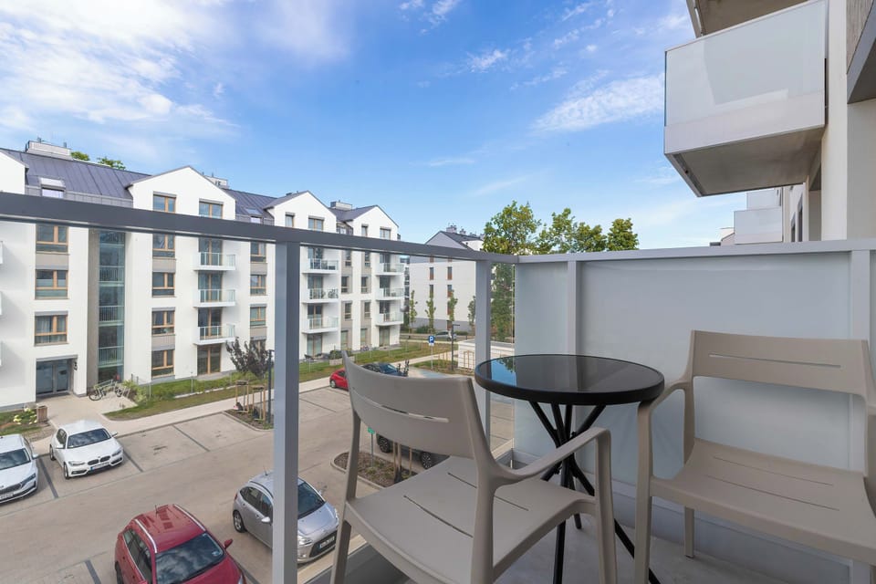 Private balcony with outdoor seating overlooking the surrounding residential area.