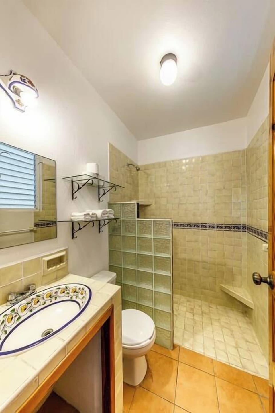 Bathroom with a tiled walk-in shower.