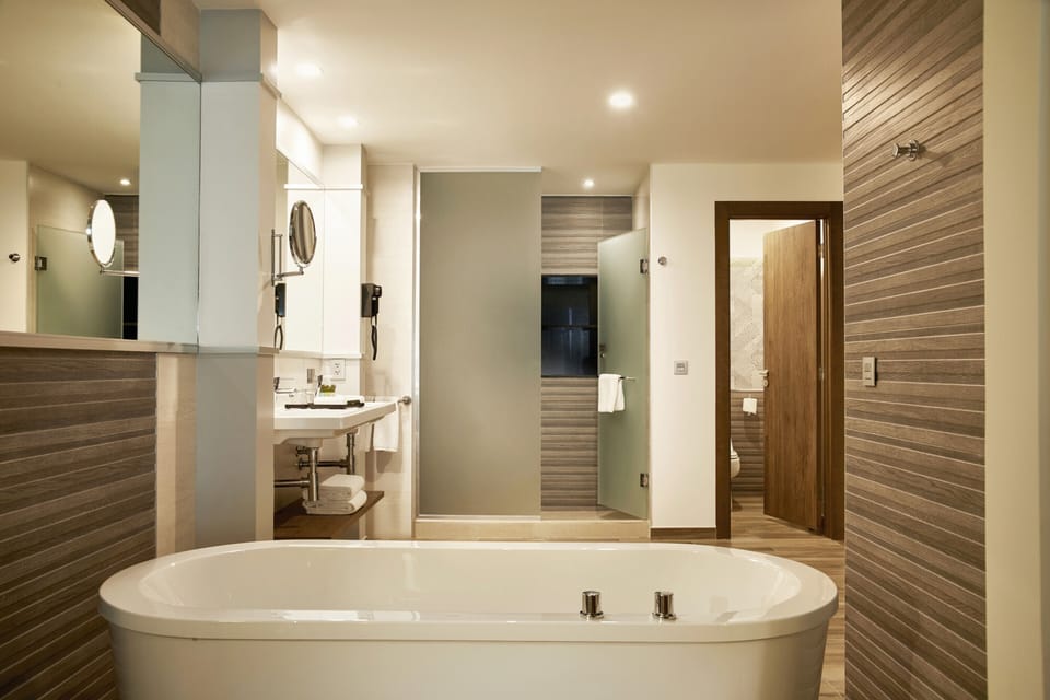 Separate tub and shower, rainfall showerhead, designer toiletries