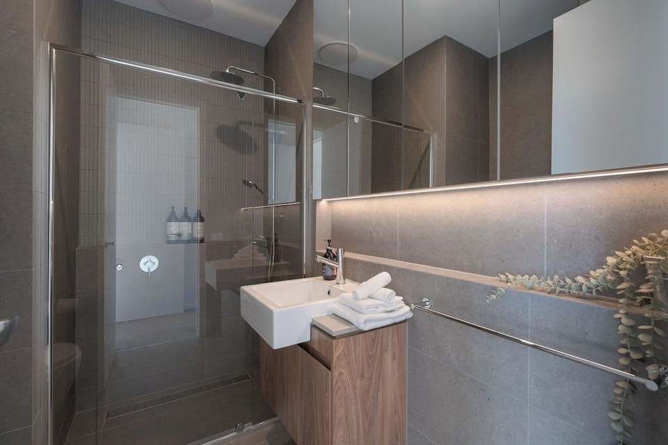 Private ensuite adjoining the master bedroom, complete with toilet, walk-in shower, modern vanity and sleek contemporary finishes.