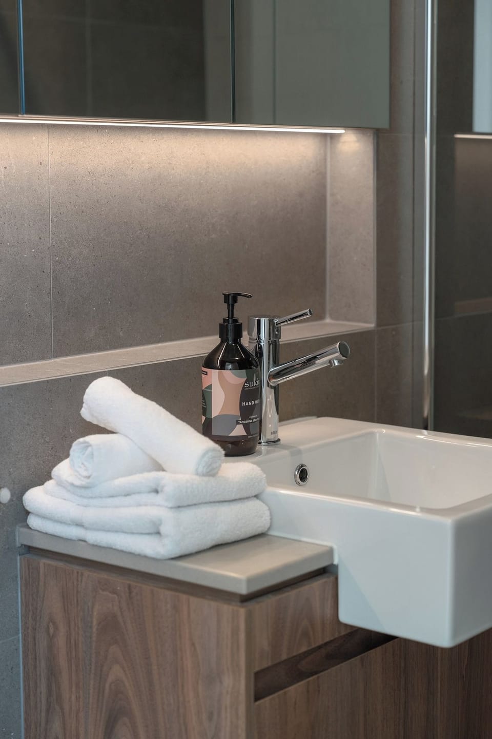 Bedroom 2 guests enjoy their own bathroom space, with fresh towels, hand wash and mirrored storage provided.