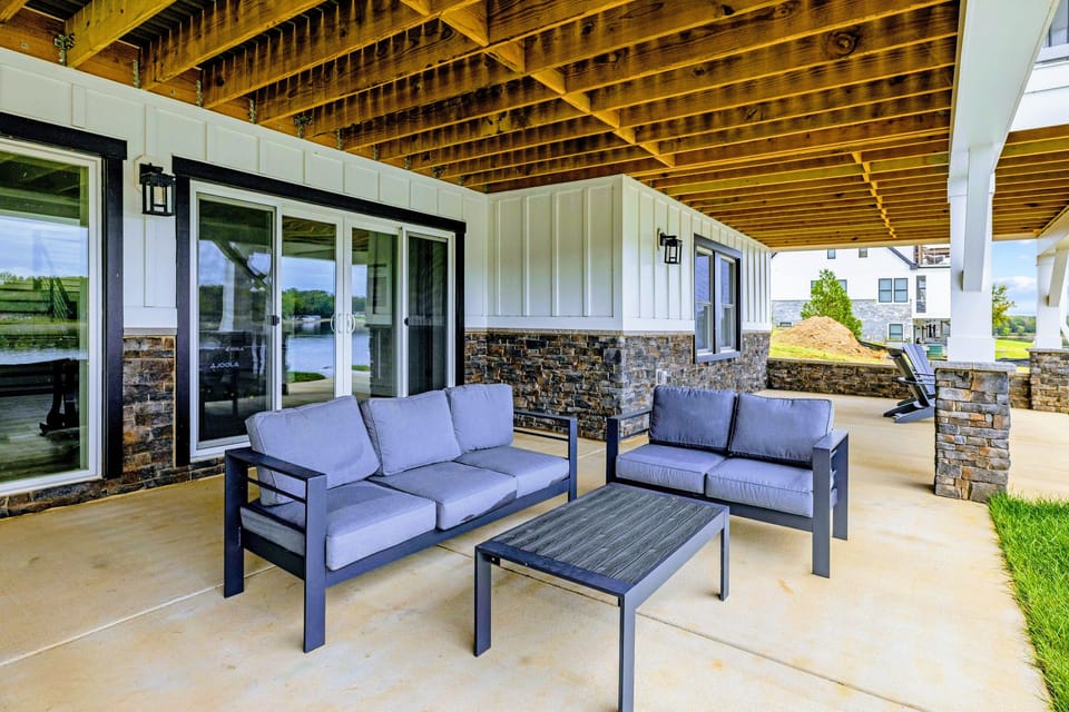 Lower Patio - Outdoor sofa and loveseat outside the game room doors on the covered lower patio.