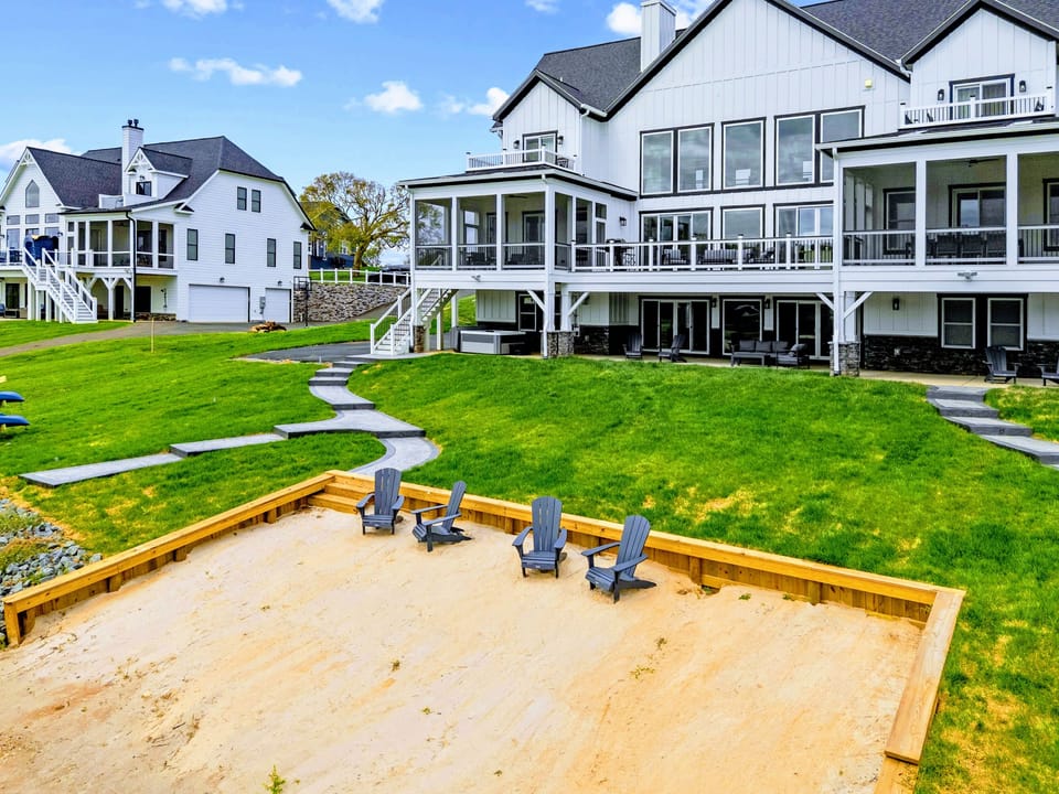 Beach - The framed sand beach with the home and its porches on the rise behind it.
