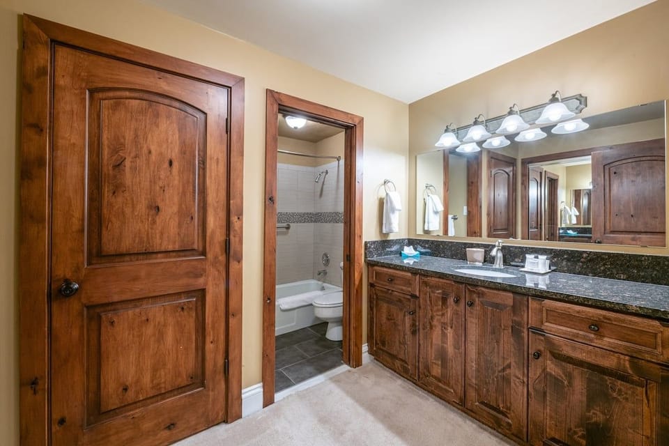 Rich wood details, generous counter space, and a well-appointed layout make this bathroom a standout feature of Resort Plaza 5031. Every comfort has been considered for the perfect Park City lodging experience.