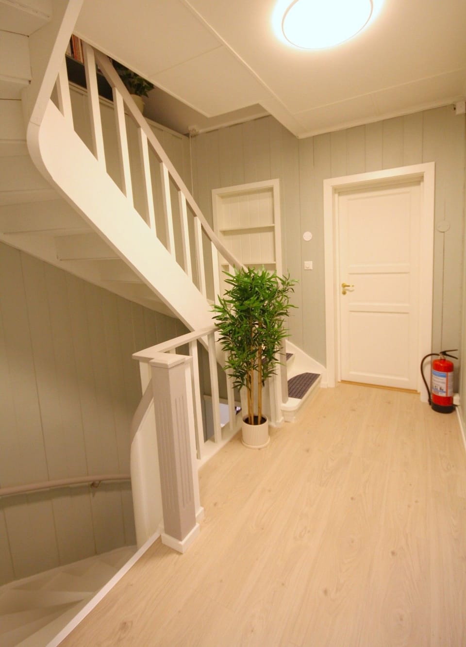Stairs from the hallway up to main floor and from main floor up to top floor