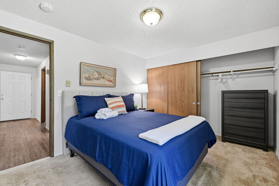 Bright cozy bedroom with plush bedding and spacious closet storage