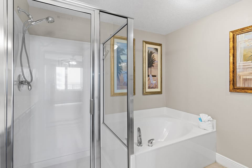 Primary ensuite bathroom with walk-in shower and large bathtub
