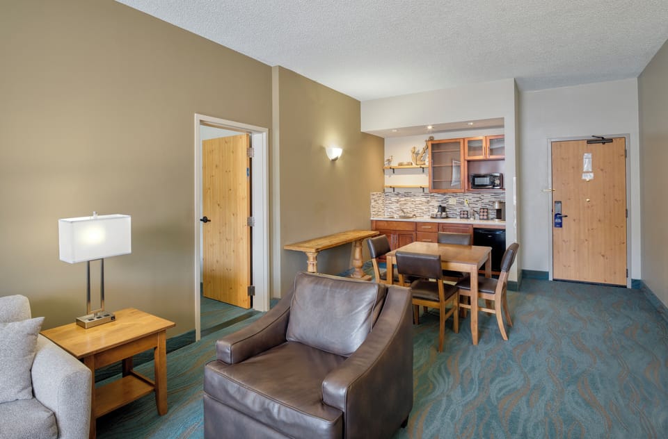 Suite, 1 King Bed | Living area | 32-inch TV with cable channels, iPod dock