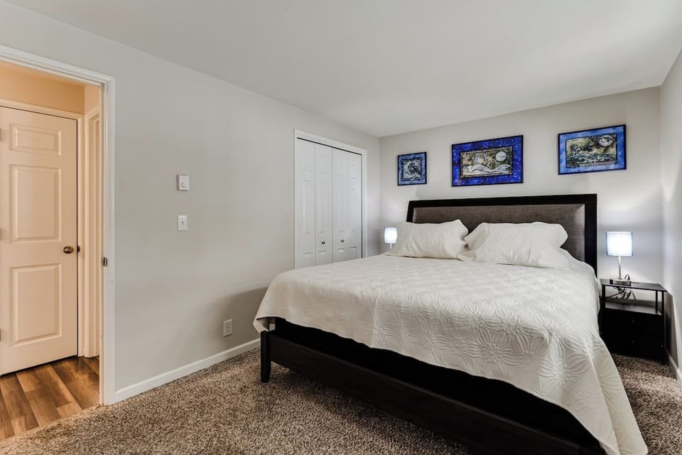 Comfy master bedroom with nightstands + lamps on each side of the bed