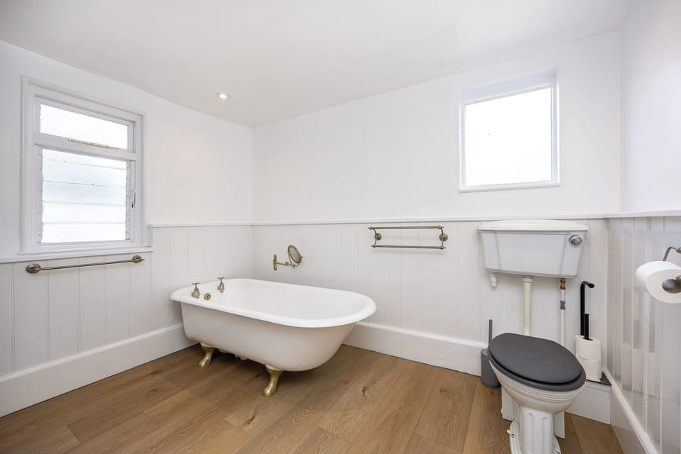 Spacious bathroom with a freestanding bath and a clean, classic finish. Light and airy, with a simple, practical layout and everything needed for a comfortable, relaxed stay.